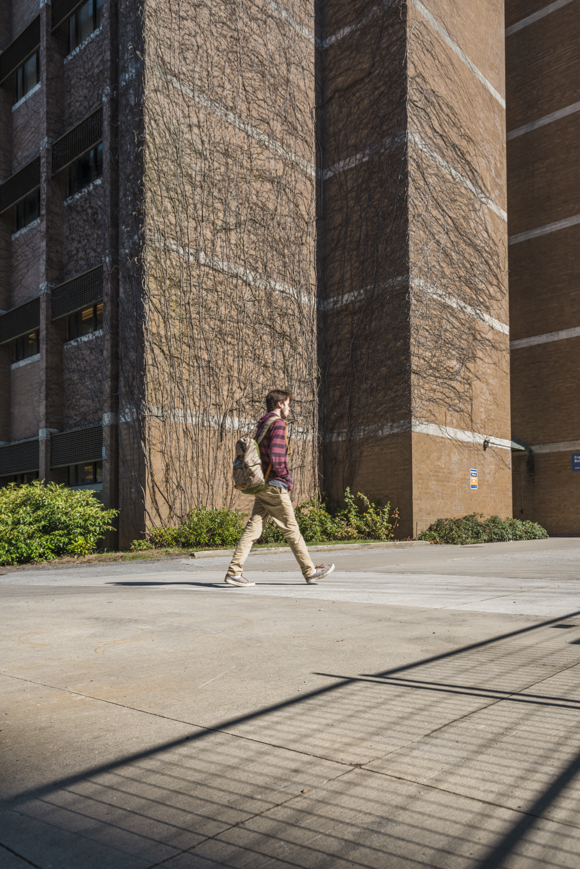 A student walking by the Forward Building at UBC Vancouver.
