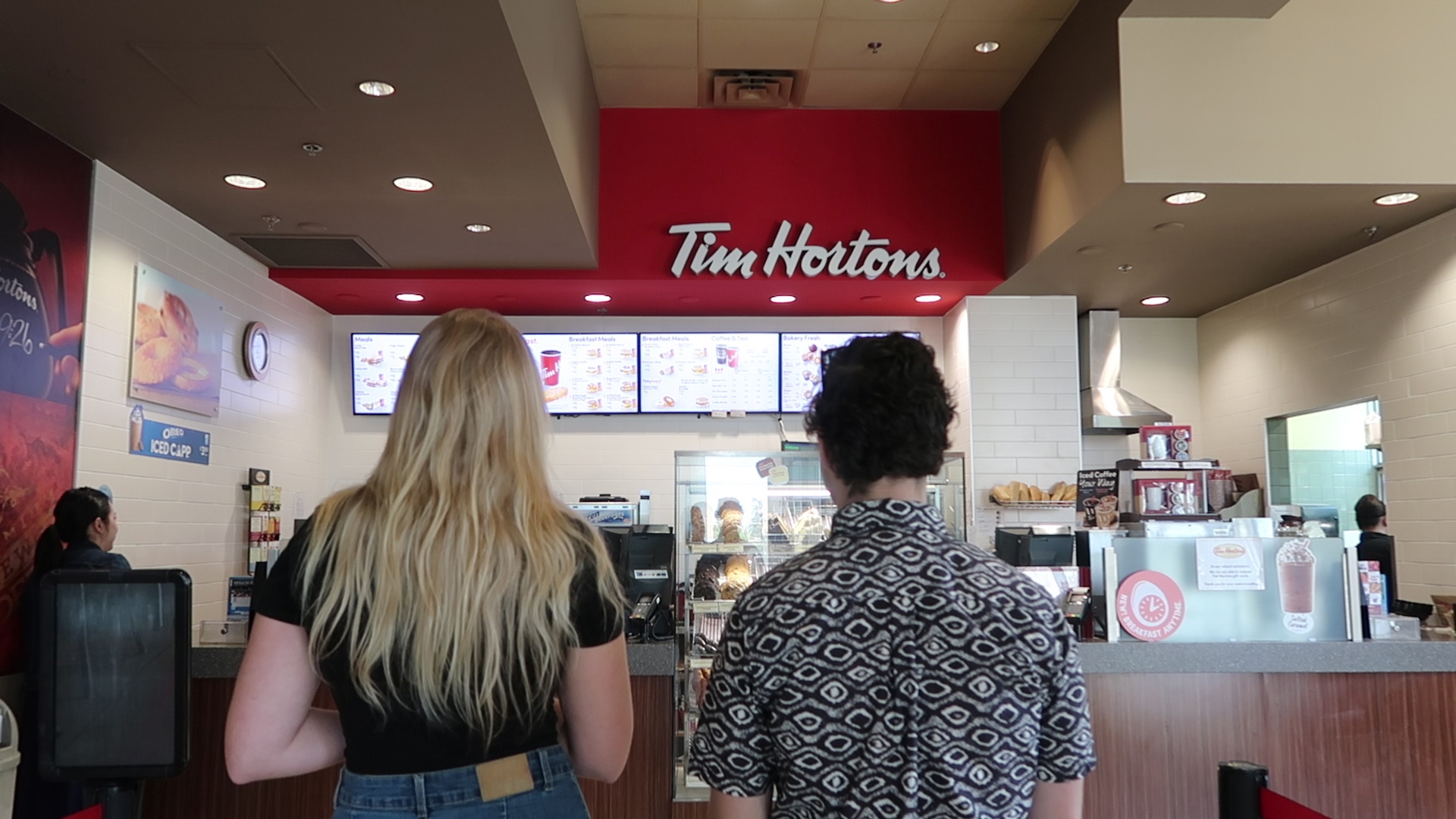 two students waiting in line at Tim hortons