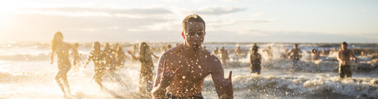 Students on Wreck Beach participating in UBC's Polar Bear swim