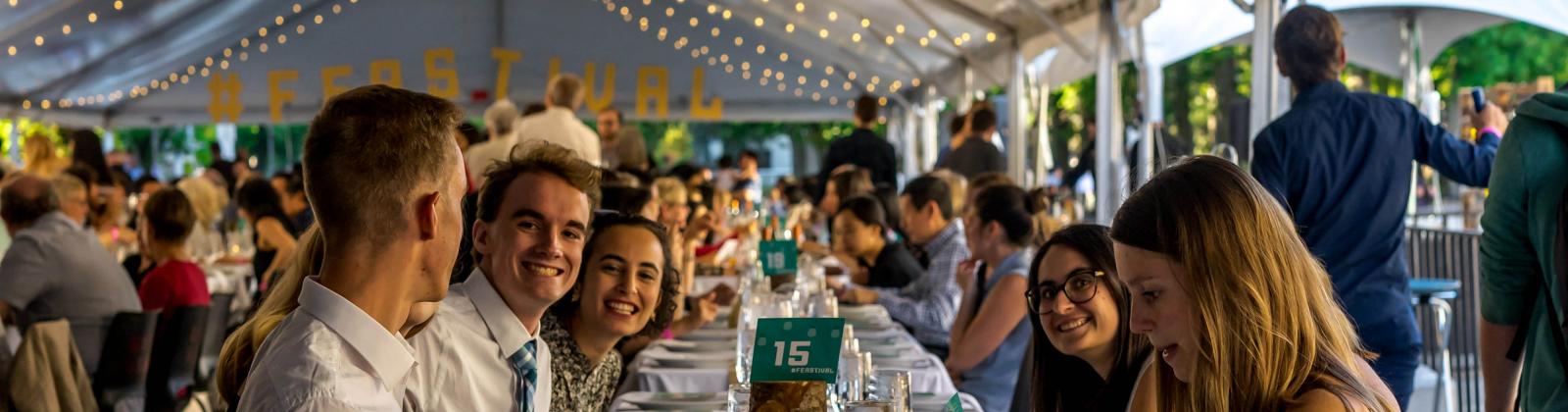 Students seated at long table for the Harvest Feastival