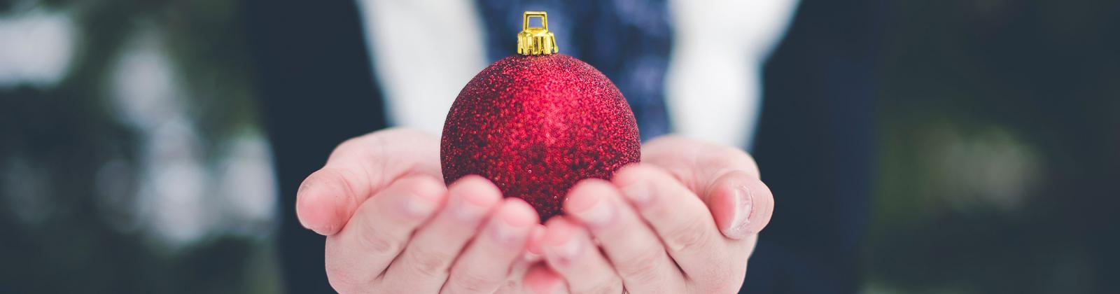 Student holding a Christmas ornament