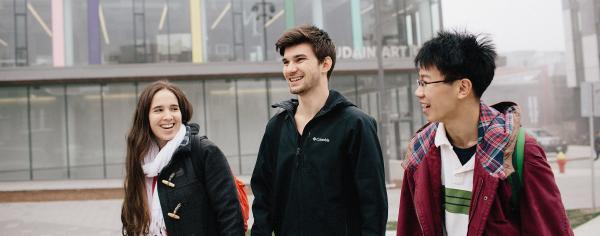 Three students walking together outside at UBC