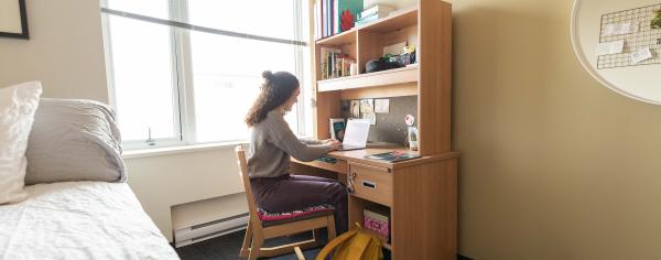 A student in a residence room