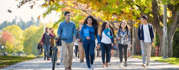 Students walking outside on a sunny fall day at UBC