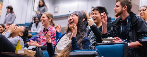 Students laughing at an SLC presentation