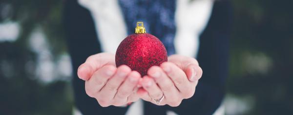 Student holding a Christmas ornament
