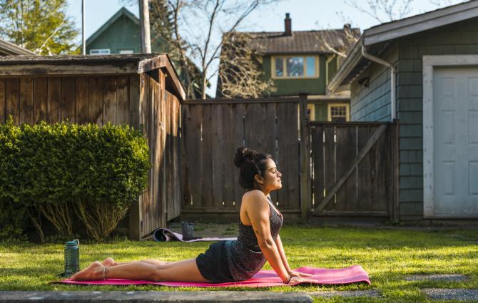 student doing yoga in the backyard