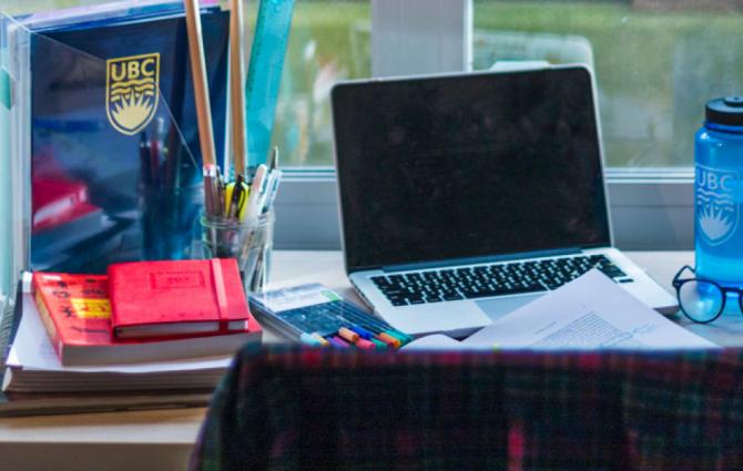A student's desk with laptop and books