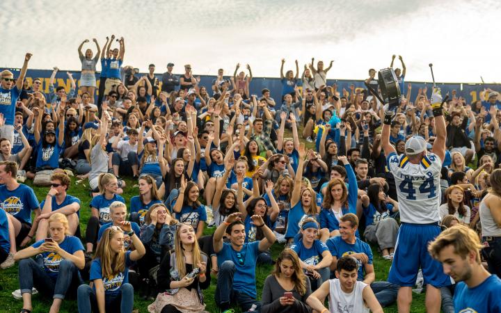 UBC students and alumni cheer on the Thunderbirds football team at Homecoming