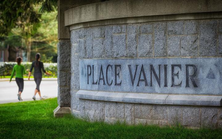 A close up view of a stone sign reading "Place Vanier"