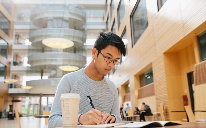 A UBC student studying in the Life Sciences building.