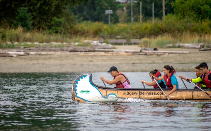 Students racing in a longboat
