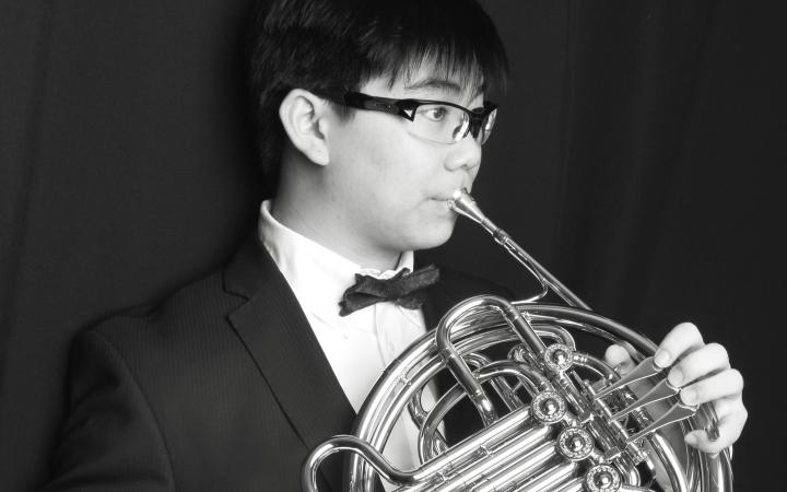 Albert Wu, a UBC student, posing with a french horn