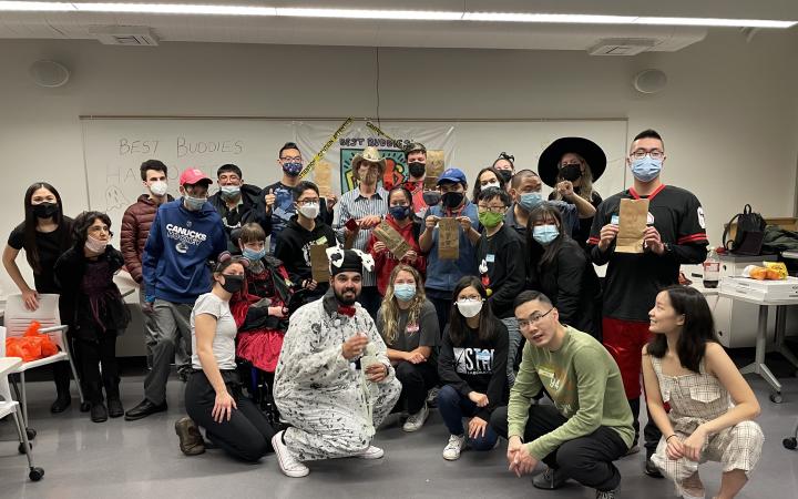 A photograph of the group Best Buddies at their Halloween event, all of the members are wearing costumes.
