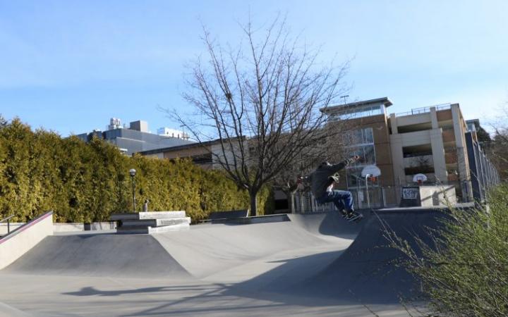 The skate park with the parking garage in the background