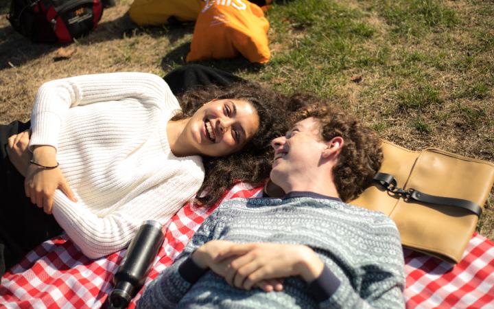 students lying on grass