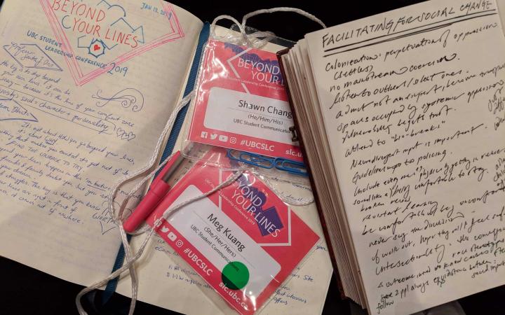 A photograph of two notebooks and conference badges taken at the 2019 SLC