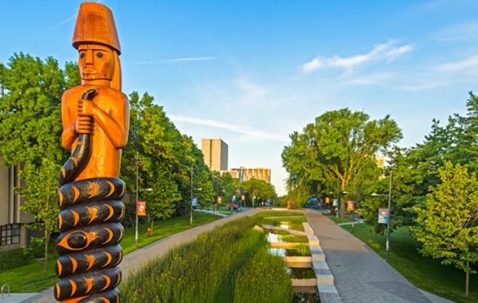 Musqueam Post in the foreground, University Boulevard on UBC Vancouver campus